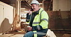 Carpentry, coffee and phone call with happy man in factory for feedback, report or update. Communication, contact and drink with mature person laughing in woodworking factory for planning or review