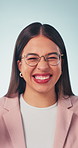 Face, businesswoman and excited in studio with celebration, glasses and good news for job promotion. Happy, person and cheering with career development, success and achievement on blue background.