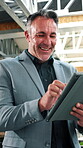 Businessman, tablet and smile in office for finance, news and happy for investment opportunity. Mature financial manager, tech and scroll in agency for economy research, stock increase or trading app