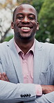 Crossed arms, black man and face of lawyer in city with confidence for legal career outdoor. Happy, about us and portrait of environmental attorney with pride for sustainable law case in urban town.