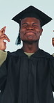 Graduation, university and black man with fingers crossed in studio for achievement, education or future career. Hope, opportunity and college student with wish, scholarship dream and blue background