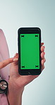 Nurse, pointing and hands with phone, green screen and presentation for telehealth app or healthcare. Blue background, medical expert and person with mobile, mock up space and promotion in studio