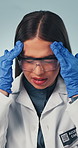 Scientist, woman and headache in studio for research pressure, experiment fail or funding loss. Science professional, person and migraine for medical mistake, stress and burnout on background