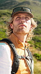 Thinking, nature and man on mountain for hiking, adventure and trekking for tourism or holiday. Reflection, active and person with break for travel, vacation and backpacking outdoor for wellness