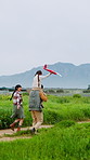 Family, playing and child on shoulder with airplane in nature for fun trip, bonding or weekend together. Mom, dad and carrying kid with aeroplane for outdoor holiday or adventure in countryside