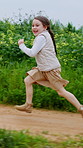 Happy, girl and running in countryside for playful weekend, adventure or outdoor journey in nature Child, kid or playing with smile on dirt road for fun childhood, holiday or development on farmland