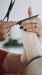 Woman, hairdresser and hands in salon for haircut, hair maintenance and grooming service. Client, stylist and scissors in beauty parlor for trimming, customer experience and haircare for makeover
