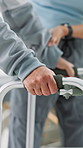Physical therapy, hands and patient with walker, healthcare and support for rehabilitation in clinic. Physiotherapist, help and person with disability, balance and walking with assistance or wellness