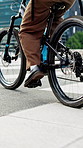 Bicycle, cycling and legs of delivery man in city for order transportation, logistics or cargo. Outdoor, courier and distribution worker on bike for commuting with ecommerce package  in urban town.