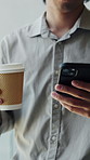 Man, hands and coffee in office with phone, social media post and text message on walk for break. Person, browsing online and tech in business with email alert, mobile chat and beverage for work.