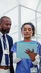 Doctor, nurse and folder in hospital with discussion, schedule management or explain medical report. Low angle, healthcare worker and people in clinic with file, manager and conversation for admin.