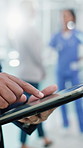 Doctor, hands and typing in hospital with tablet, online research and AI for healthcare management. Medical worker, man and digital tech with planning, internet connection and innovation for clinic.