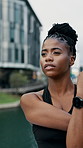 Fitness, thinking or black woman stretching in city for workout preparation or outdoor exercise. Thoughtful, active or happy female person getting ready with smile or arm warm up for training in town