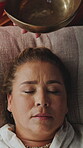 Meditation, healer or woman with tibetan bowl, spiritual practice or stress relief in holistic health. Zen, practitioner or client with tool, sound therapy or grounding vibration in wellness session.