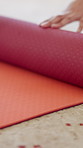 Roll, start and hands of person with yoga mat for holistic exercise, wellness and health in studio. Morning, floor and woman with equipment to begin pilates, workout routine and hobby for wellbeing