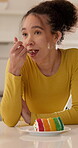 Eating, cake and woman on break in kitchen, smile and relax with tasty snack and junk food in house. Morning, treat and happy person with sweet tooth, satisfied and delicious dessert in apartment