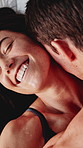 Happy, couple and kiss with intimacy in bed for sensual romance, affection or love in home. Top view, man and woman with smile, touch or lust for seductive intercourse, desire or pleasure in bedroom