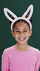 Bunny ears, dress up and face of little girl on studio background for celebration or holiday. Easter, rabbit costume and smile of happy child on backdrop for development, event or excitement