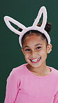 Bunny ears, easter and face of little girl on studio background for celebration or holiday. Dress up, rabbit costume and smile of happy child on backdrop for development, event or excitement