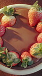 Baking, strawberries and chocolate pudding on table for mousse dessert, gourmet treat and decadent. Presentation, fruit series and ganache on above for cocoa snack, creamy recipe and parfait in home