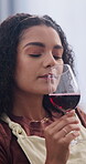 Break, tasting or woman in home with red wine, drink aroma or peaceful moment with flavor sampling. Calm, sniff or person in lounge with alcohol glass, weekend unwind or satisfaction in sip activity.