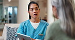 Diagnosis, tablet and nurse with old woman on sofa in home for consulting, medical app and help. Caregiver, support and healthcare review with people in living room for healing and online checklist