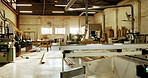 Empty, factory and wood with machinery for carpentry, furniture restoration and lumber manufacturing. Flare, workshop and timber with equipment for woodwork project, production or industrial business