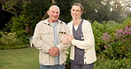 Face, caregiver and smile at park with old man, support and fresh air for medical service. Portrait, nurse and senior person in nature with happiness, assisted living and elderly care for retirement