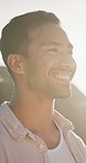 Thinking, calm and man outdoor with fresh air, trip memory and mindfulness on summer holiday. Happy, flare and person in nature with breathing, reflection and peaceful perspective on getaway break.