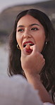 Couple, feeding and woman at beach for travel, picnic and romantic anniversary for summer holiday. Smile, people and eating at sea with healthy fruit, getaway date and partner celebration on vacation