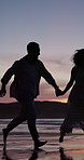 Sunset, couple and running in ocean with travel adventure, holding hands and love for summer holiday. Evening, silhouette and people outdoor at beach with relationship, romantic getaway and vacation.