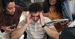 Headache, man and stress in office with team, overwhelmed and paperwork with phone for overwork. Coworkers, migraine and tired person with overload, tablet and deadline pressure with challenge