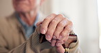 Elderly, man and hands with cane in retirement home for mobility, assistance or movement aid. Senior, male person or thinking with walking stick for nostalgia, support or assisted living in house
