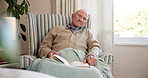 Senior, man and sleeping with book in retirement home for snooze, nap or rest on chair. Calm, elderly or male person asleep with story, novel or tale for pension, holiday or weekend in old age house