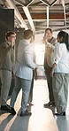Happy, meeting and business people with high five in office building for winning or teamwork. Group, employees or colleagues with smile or lens flare for company success or achievement in workplace