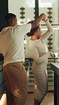 Dancing, spin and couple in kitchen with music for bonding, connection or romantic moment on weekend. Marriage, happy and African man and woman with song, movement and love for relationship in home