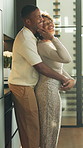 Dancing, love and couple in kitchen with embrace for bonding, connection and romantic moment. Marriage, happy and African man and woman with music, movement and affection for relationship in home