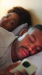 Night, bedroom and couple with phone for secret text, cheating and suspicious for infidelity. Jealousy, home and African man and woman on cellphone for online dating, message or relationship conflict