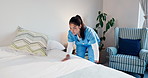 Tidy, nurse and making up bed in nursing home for maintenance, assisted living and support. Caregiver, facility and woman in bedroom for cleaning, housekeeping service and change bedding for hygiene