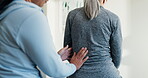 Back pain, massage and women in physical therapy session for healing, consultation and healthcare. Person, senior patient and spine injury with rehabilitation, chiropractic and joint wellness