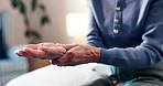 Hands, wrist pain and elderly woman in bedroom for joint ache, arthritis or orthopedic injury in home. Senior person, medical issue or tension with osteoporosis, fibromyalgia or massage in retirement