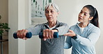 Physiotherapist, support and old woman in clinic with dumbbells, strength exercise or rehabilitation. Senior person, healthcare worker and help with workout, weights and fitness for injury recovery.