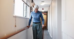 Walking, corridor and senior woman with cane for mobility, movement support or help in nursing home. Retirement, facility and person with disability in hallway for recovery, rehabilitation and health
