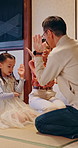 Playing, happy and parents with Asian child in home for traditional game, bonding and learning. Family, laugh and girl with mom, dad and playful relationship for development, love and care in Japan