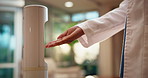 Dispenser, spray and doctor with hand sanitizer in hospital for hygiene, disinfection and germ prevention. Healthcare, clinic and woman with liquid for bacteria, protection and wellness for health