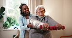 Physio, help and senior woman with dumbbells for exercise, strength and rehabilitation in clinic. Healthcare worker, elderly person and lifting weights for physical therapy, arm mobility and support.