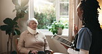 Tablet, nurse and old woman with brace in home for healthcare, recovery or rehabilitation. Tech, injury and medical support with caregiver speaking to senior patient in assisted living for help