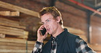 Carpenter, phone call and man in workshop talking for furniture project, timber production and update. Carpentry, contractor and person on cellphone for communication, contact or chat for woodworking