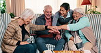 Nursing home, nurse and hands stack with old people, laughing or bonding with friends in living room. Happy, caregiver and celebration with senior group, retirement or clapping for healthcare service