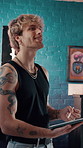 Thinking, tablet or tattoo artist in studio with drawing, online draft or digital planning on creative app. Happy, man or ink specialist with pen, sketch ideas or body design in artistic process.